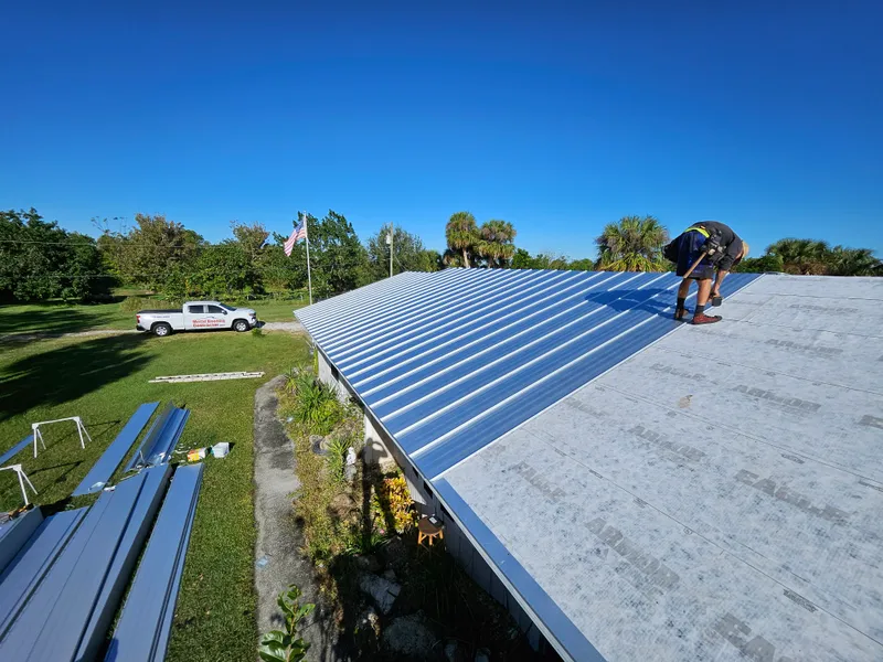 Metal Roofing Contractor crew installing metal roof panels on a Florida home